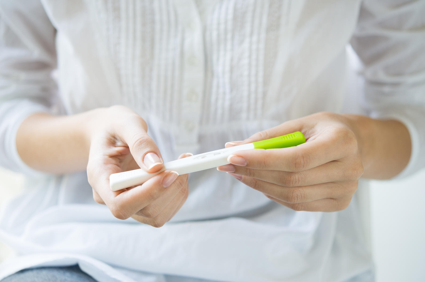 woman looking at pregnancy test