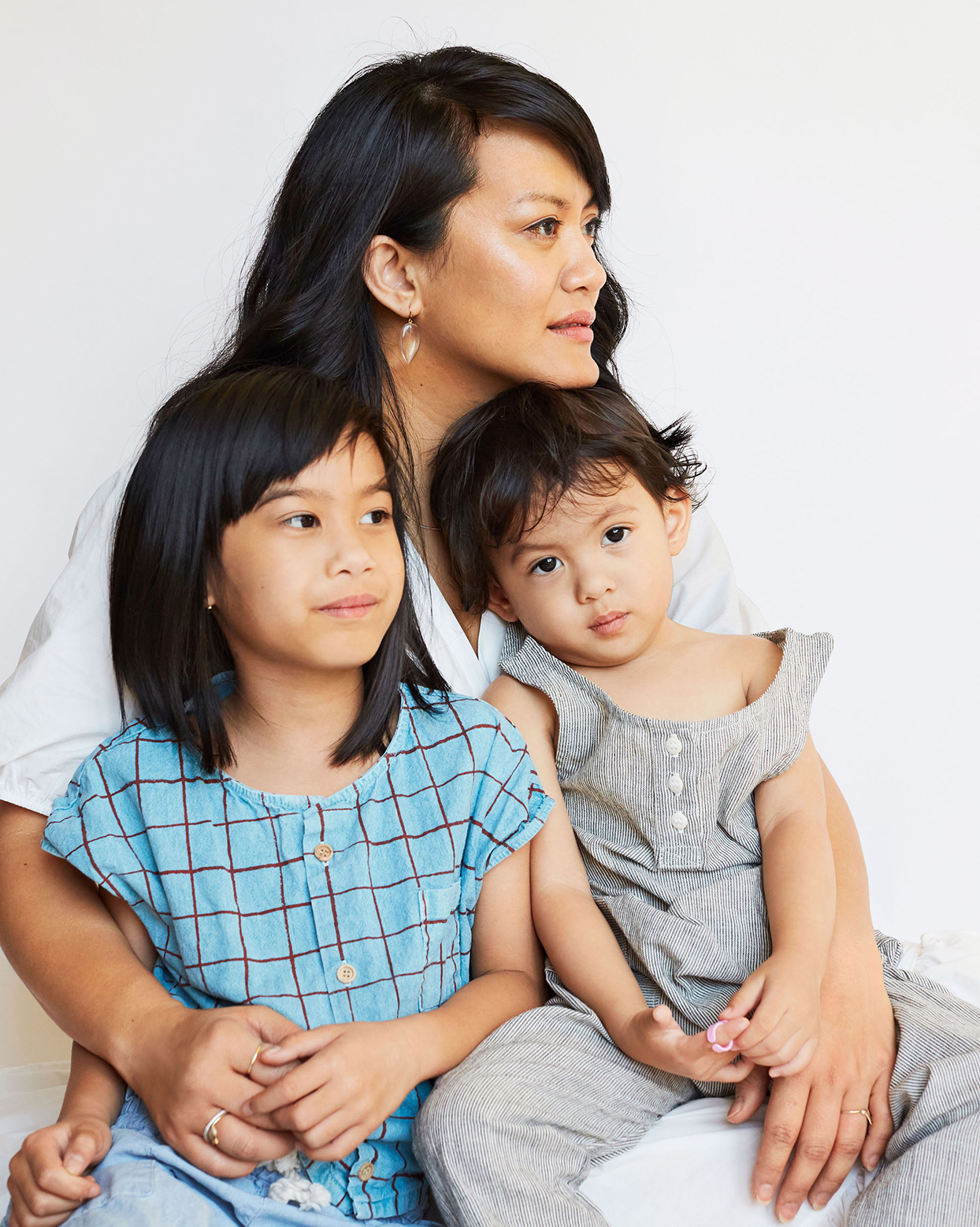 mom holding two small children