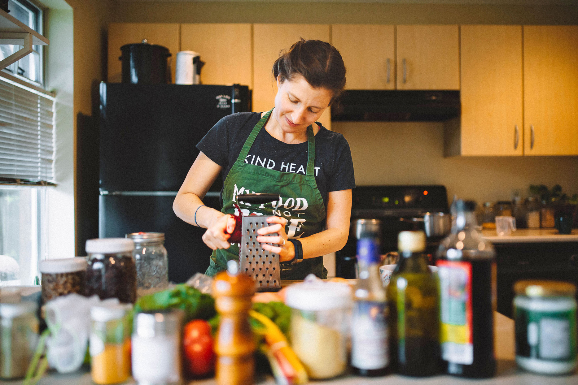 woman grating beet in kitchen