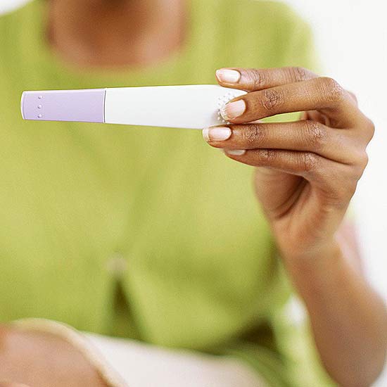 woman holding pregnancy test