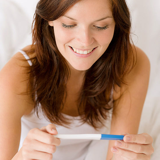 woman holding pregnancy test