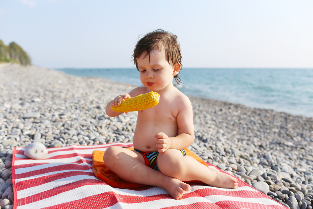 Summer Eats Toddler Eating Corn On The Beach