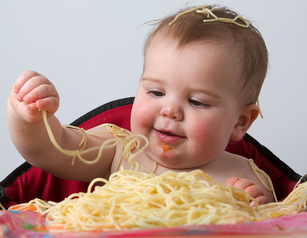 baby eating pasta