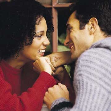 couple eating at restaurant and feeding each other