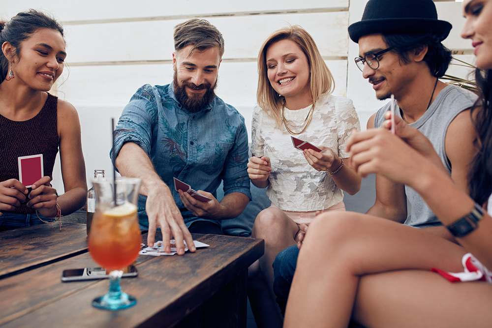 Parents playing cards like KinderPerfect, the Cards Against Humanity inspired game for moms and dads.