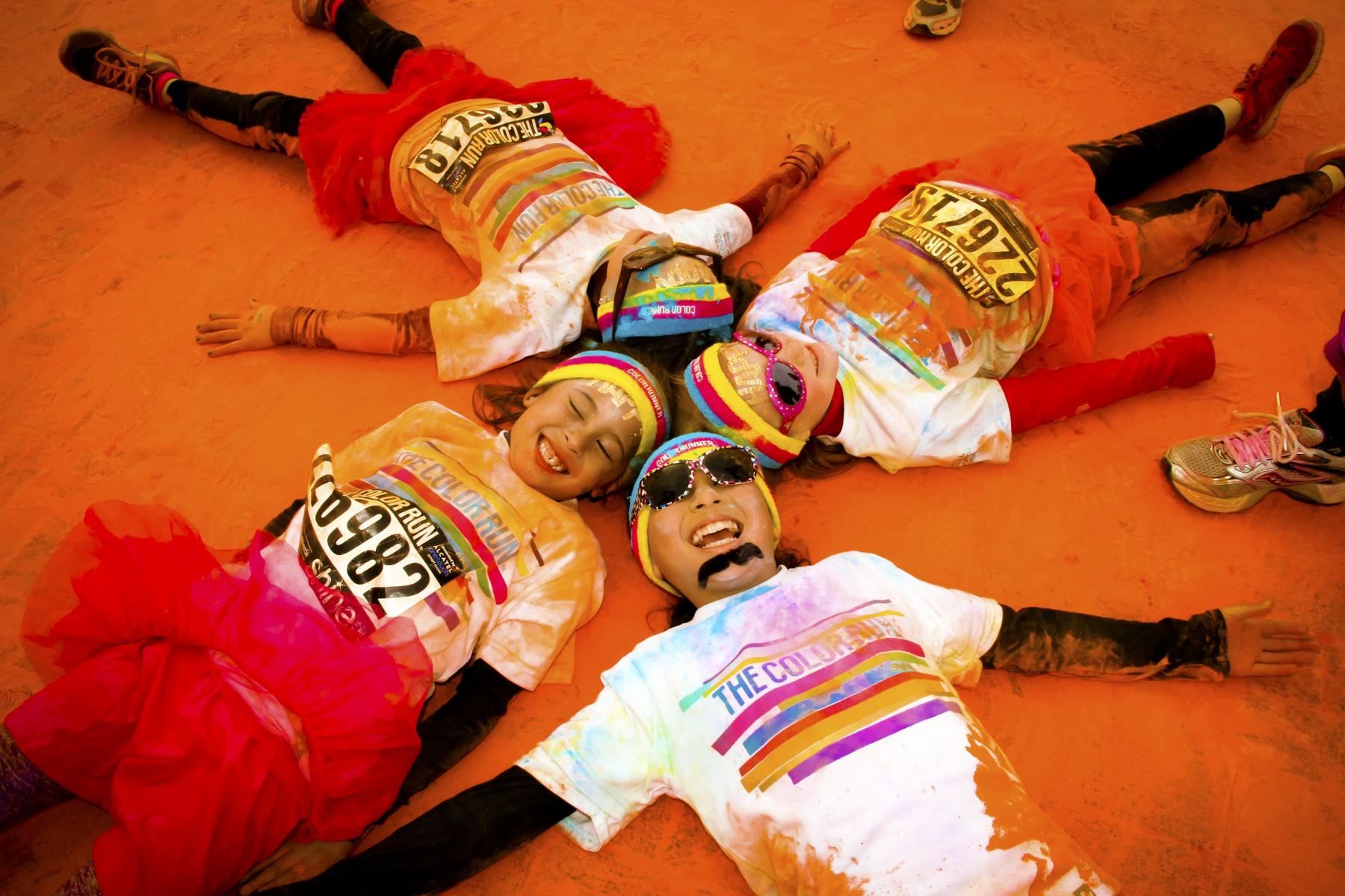 Family 5K Kids Laying In Circle Covered In Orange From The Color Run