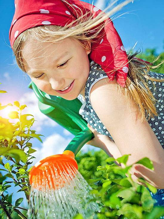 child watering garden